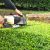 Man trimming garden hedge